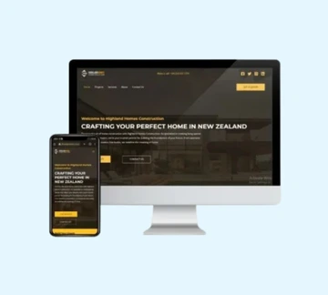 A smartphone and a computer monitor display the same website homepage for a New Zealand home construction company, featuring dark and gold colors on a light blue background.