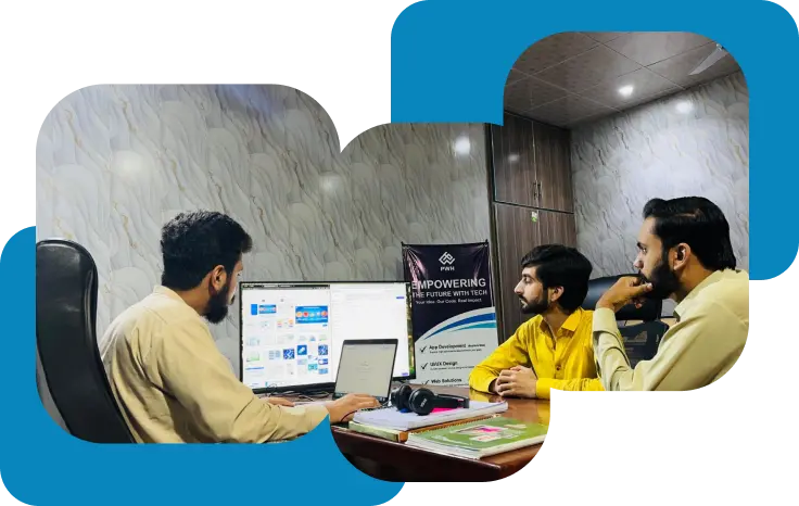 Three men sit at a desk in an office, looking at a computer monitor displaying a website. Papers, a notebook, and headphones are on the desk. A banner behind them reads Empowering the future with tech.